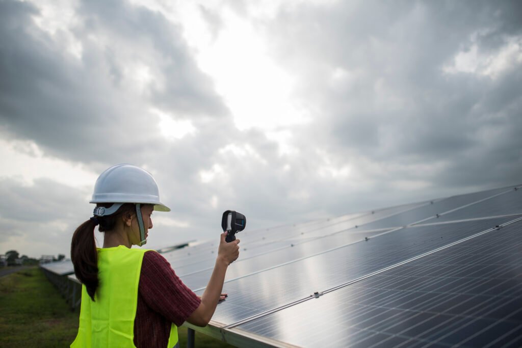 engineer electric woman checking and maintenance of solar cells.