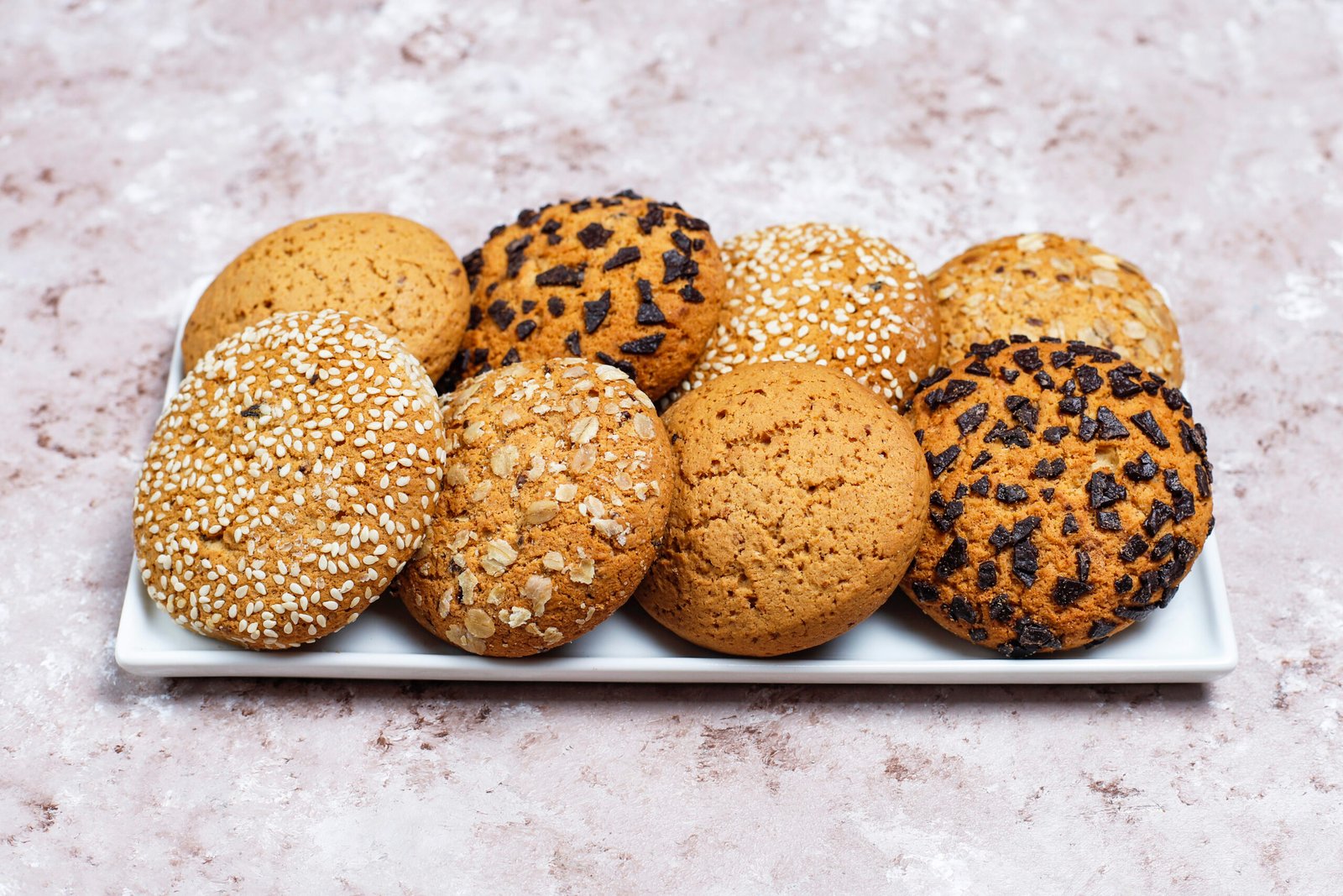 set of various american style cookies on a light concrete backgr